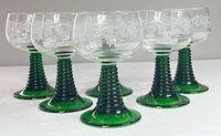 Front angled group view of six glasses showing bowl etching and green beehive stems