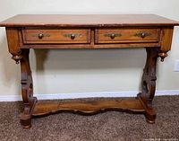 Front view of solid wood console table showing drawers and legs