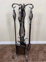Full view of fireplace tool set with stand showing all tools