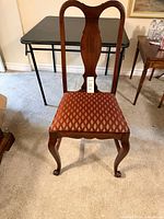 Full view of chair showing back, seat upholstery, and overall condition