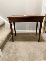 Full view of piano bench beside staircase