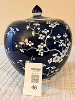Front view of blue and white blossom ceramic pot with lid