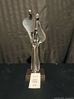 Full front view of brass family sculpture on base