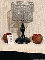 Full lot showing two PartyLite tea light holders and tall pedestal candle holder