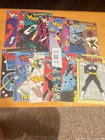 All 14 Vigilante comic books spread out showing covers
