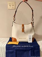 full view of purse on dust bag with registration card visible