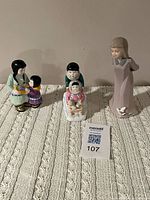 Front view of all three figurines showing relative sizes and details