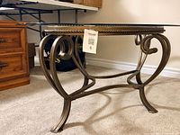 Side view showing glass top, rope detail, scroll metal legs