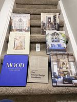 All seven hardcover home decor books displayed on stairs
