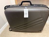 Front view of charcoal Jaguar hard shell suitcase