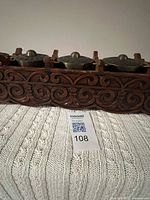 Front close view of carved rack and gongs