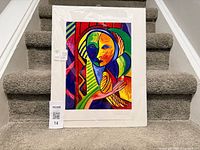 Front view of the unframed signed and numbered print resting on stairs