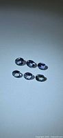 Six oval tanzanites on neutral background