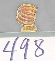 Front view of gold tie tack showing wavy design and diamond chip