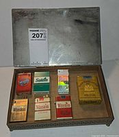 Open Benson & Hedges box displaying six cigarette-pack lighters