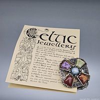 Front view of Celtic brooch and accompanying information card