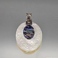 Front view showing entire carved mother-of-pearl pendant, abalone inlay, and sterling bail