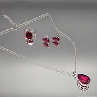 Full view of necklace, ring and earrings showing matching design and scale