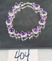 Full view of bracelet closed in circle showing all heart links and clasp