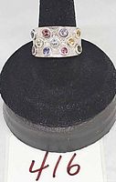 Front view of wide sterling silver ring showing multicolour gemstones