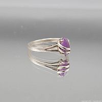 Side view of sterling ring showing marquise purple stone in prong setting