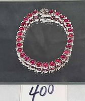 Full view of red gemstone sterling silver tennis bracelet