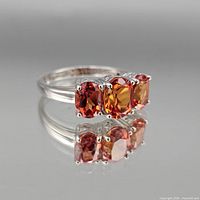 Front view of sterling silver ring showing three orange-red oval stones