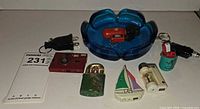 Overall lot showing ashtray and assortment of novelty lighters