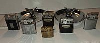 Front view of both ashtrays and six lighters