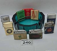 Group shot of six lighters, glass ashtray and four matchbooks