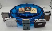 Group shot: five lighters, ashtray, three matchbooks