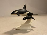 Front view of John Perry orca sculpture showing both whales and base
