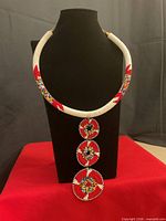Full view of beaded collar necklace with three pendant drops on display bust