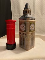 Front view of Big Ben tin and red pillar box bank side by side