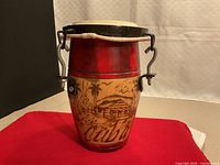 Front view showing carving, hide head, metal hooks