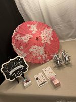 Group shot of all items including parasol, sign, balloon weights, bubble wands, stickers, silicone rings