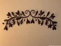 Full view of bronze toned metal leafy branch wall art
