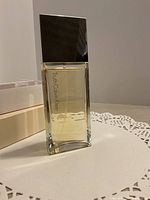 Front view of full bottle showing cap, liquid level, and logo