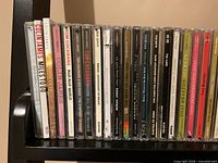 Row of CD jewel cases showing artist and album titles