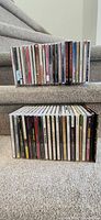 Two stacks of about 50 CD jewel cases on stairs