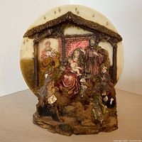 Front view of assembled resin nativity plate in stand