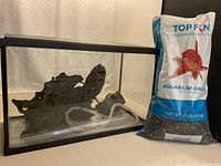 Aquarium, gravel bag, tubing and filter visible
