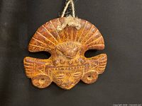 Front view of mottled clay face mask with jute hanger