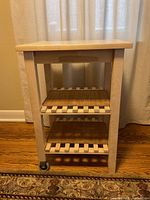 Full view of IKEA Bekväm cart showing top and two lower slatted shelves