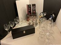 Overall lot view with glasses, aerator boxes, rack, tray and gift box