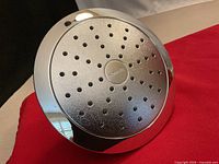 Front view of round Kohler shower head showing spray nozzles