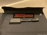 Panel unfolded showing MotoMaster Eliminator logo and output lead with connector