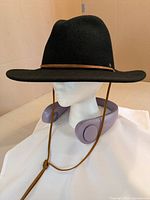 Side view of MITO lavender neck fan displayed on mannequin with hat prop