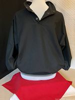 Front view of dark navy SunCruz pullover golf shell on mannequin