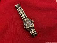 Front view of Swiss Army wristwatch on red background